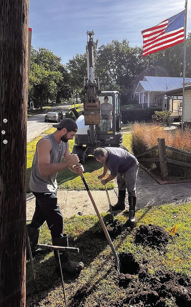 City crew members cautiously dig to uncover natural gas lines before restoring water