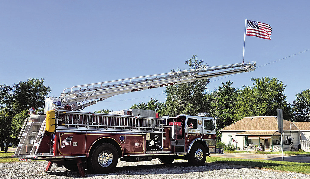 Pawnee City Firetruck hoists the American Flag on September 11th as we remember the lives lost. Photo by Betty Davis