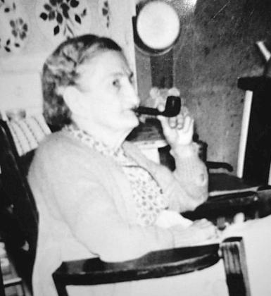 Bessie Penn sitting in her rocking chair with her corn cob pipe, from Brenda Byfield Jones.