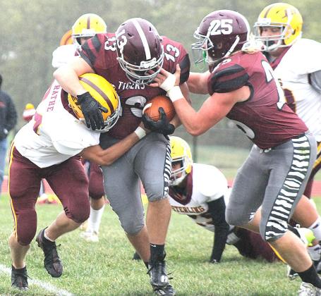 Lewiston’s Brady Bledsaw (#13, center) surges forward for extra yardage as teammate Tristen Ray (#25, right) tries to help out in the Tigers’ Homecoming game. Paula Jasa/Republican