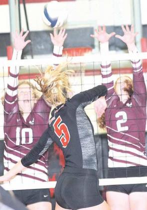 P.C.’s Sierra deKoning (#5) powers a kill past two Sterling defenders on Thursday night. Paula Jasa/Republican