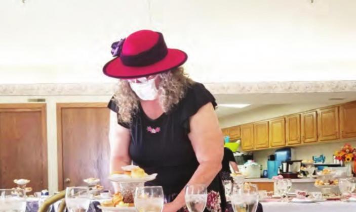 Suzanne Ellis helps set the tables