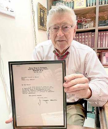 Pawnee City attorney Joe Stehlik holds up the letter from J. Edgar Hoover announcing that Judge William F. Colwell was appointed to serve in the FBI. Ray Kappel/Republican