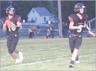 P.C.’s Anthony Kling (#16, left) takes the pitch from quarterback Justin Pierce (#5, right) looking for a touchdown pass. Paula Jasa/Republican