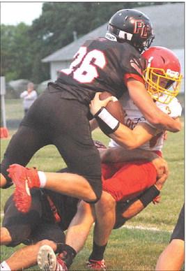 P.C.’s Trey Marteney (#26) makes a big stop against Red Cloud in Friday night’s game. Marteney had 8 tackles with 1 blocked punt in the game. Paula Jasa/Republican
