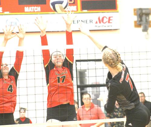 Pawnee City’s Adrian deKoning (#7, right) powers a spike past two JCC defenders in Thursday night’s game. Paula Jasa/Republican