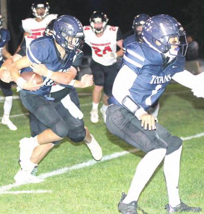 HTRS’ quarterback Brandt Leech (#18, left) takes off over the right side with teammate and blocker JJ McQueen (#1, right) out in front. HTRS lost their Homecoming game to JCC on Friday night by a 30-66 count. Paula Jasa/Republican