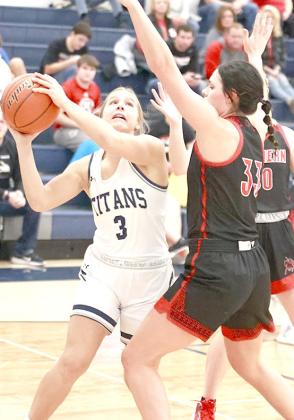 HTRS’ Laramie Glathar (#3, left) goes up for a shot underneath the basket against Wymore-Southern. photo courtesy of Lorrie Novak