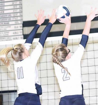 HTRS’ Katilyn Glathar (#11, left) and Aly Howe (#2, right) get their hands on a double ace block. Paula Jasa/Republican