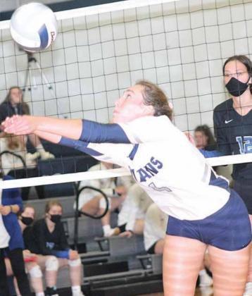 HTRS’ Natalie Novak (#4), makes a great save at the net while setting up the Lady Titan offense against NCL. Paula Jasa/Republican