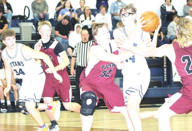 Paula Jasa/Republican HTRS’ Gage Schaardt (#14, center) draws a crowd of Lewiston players including Tristen Ray (#24, right) and Ty Arena (#32, center) as teammates Andrew Stalder (#34) and Caleb Rule (left) look on. Pictured right is LHS’ Brady Bledsaw against Stalder.