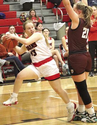 P.C.’s Ericca Gyhra (#13, left) makes an assist to a teammate on the fast break as LHS’ Maddie Janssen (#21, right) defends. Paula Jasa/Republican