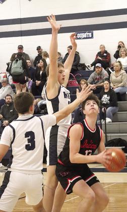 P.C.’s Tyler Tegtmeier (#13, right) goes up for a baseline shot against HTRS’ Emmett Glathar (center) and Kameon Dettmann (#3) last Tuesday. Paula Jasa/Republican