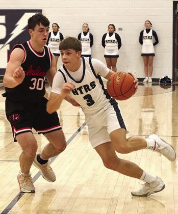 HTRS’ Kameon Dettmann (#3, right) brings the ball down against P.C.’s Jett Farwell (#30, left) in last Tuesday’s night’s game which HTRS won, 50-46. Paula Jasa/Republican