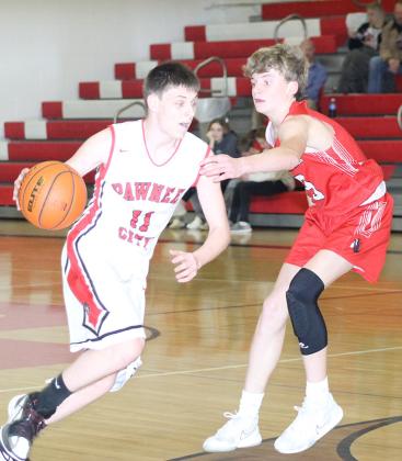 P.C.’s Brysen Horst (#11, left) drives past a surprised Weeping Water defender in a game before the Holiday break. Horst scored 10 points against Weeping Water. Paula Jasa/Republican