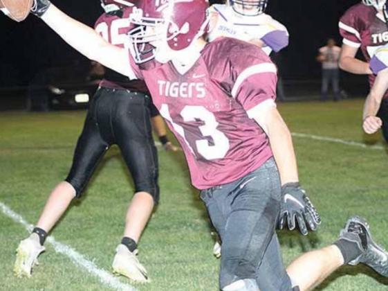LHS’ Brady Bledsaw (#13) picks up a loose ball in the backfield and turns it into a touchdown late in the game. Paula Jasa/Republican