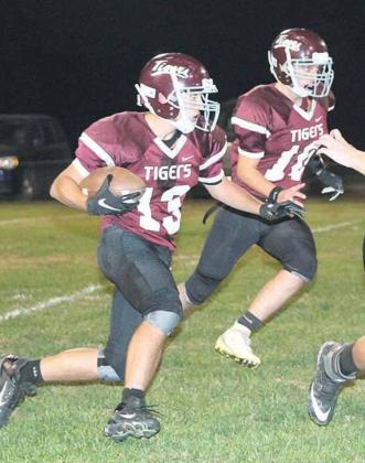 Lewiston’s Brady Bledsaw (#13, left) takes off on a run with teammate Mathew Barker (#10, right) and others out in front blocking for him. Paula Jasa/Republican