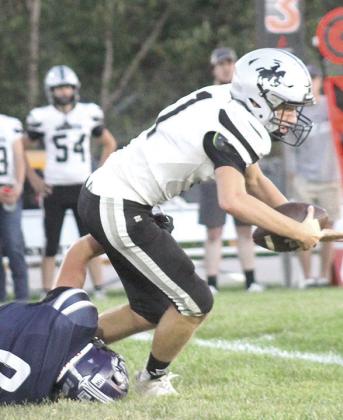 HTRS’ Emmett Glathar (#8, left) brings down the E-M quarterback on a 3rd down play. Glathar had several big plays in the game and led the Titans with 14 tackles, 1 sack and 1 fumble recovery. Paula Jasa/Republican