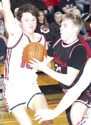P.C.’s Trey Marteney (#21, right) goes hard in the paint in the game against Johnson-Brock last Thursday. Paula Jasa/Republican