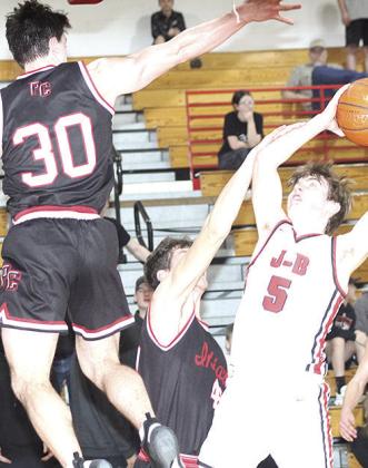 P.C.’s Oscar Machini (#40, center) and Jett Farwell (#30, left) team up on defense against J-B’s Camden Dalinghaus (#5, right). Paula Jasa/Republican