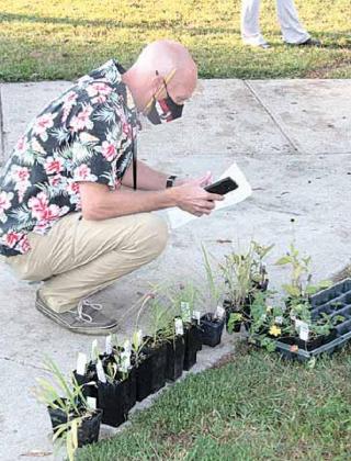 FFA advisor Mark Bloss looks over the plants.
