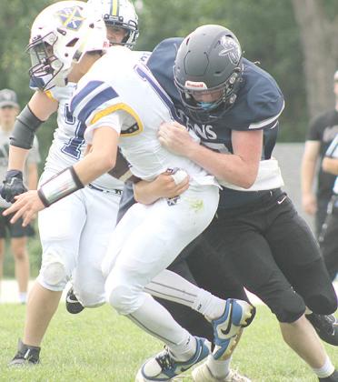 HTRS’ Colt McClarnen (#27, right) sacks the Omaha B-T quarterback on Saturday. McClarnen had 3 tackles and 1 sack in the 70-64 victory over the Raiders. Paula Jasa/Republican
