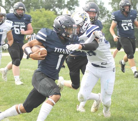 HTRS’ JJ McQueen (#1, left) stiff arms a would be Omaha B-T tackler on his way towards the end zone as teammates Dayton Eppens (#55, left), Brogan Dunlap and Alexander Jurack (#69, right) look on. McQueen had 12 rushes for 134 yards. Paula Jasa/Republican