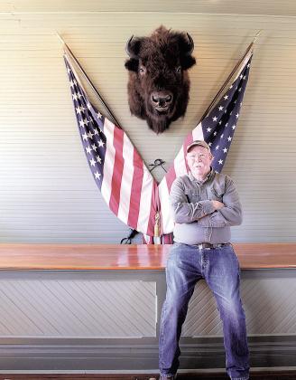 Jim Tegtmeier in his store with his prized buffalo head