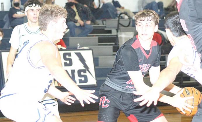 P.C’s Kaden Lang (center) looks for an open teammate as HTRS’ Andrew Stalder (#34, left) and Nic Knudson defend. Paula Jasa/Republican