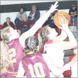P.C.’s Cameron Ottersberg (#4, right) moves past Sterling defenders to put up a shot in the lane. Paula Jasa/Republican