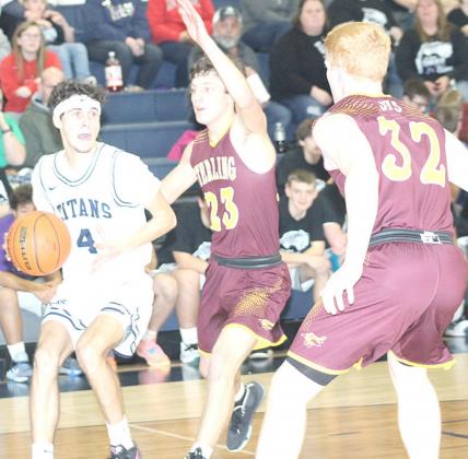 HTRS’ Nic Knudson (#4, left) drives the baseline against several Sterling defenders. Knudson poured in 28 points in the Titans’ 54-40 win over the Jets. Paula Jasa/Republican