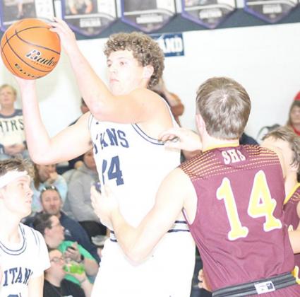 HTRS’ Andrew Stalder (#34, center) pulls down a defensive rebound against Sterling on Friday night. Paula Jasa/Republican