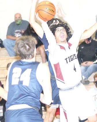 AvHTRS’ Nic Knudson (#4, above) drives against LHS’ Mathew Barker (right) while LHS’ Abel Gonzalez (#4, below) drives against HTRS’ Jacob Joy (#24). photos by Paula Jasa/Republican