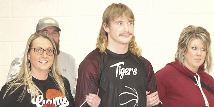 LEWISTON PARENTS’ NIGHT - Tristen Ray is accompanied by his parents prior to the Lewiston vs. Sterling boys’ game on Friday night.