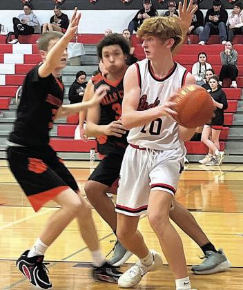 Colin Fender draws a double team as he fights for position in the paint. photo by Emily Norman