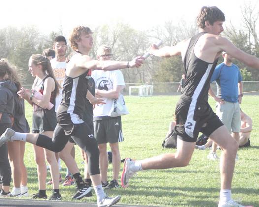 P.C’s Kyle Gyhra hands off to teammate Bryce Gyhra in the boys’ 1600 M. Relay. photo courtesty of Ann Wickett