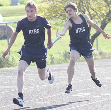 HTRS’ Will Stalder takes the handoff from teammate Ethan Dierberger in the 400 M. Relay. The Titans finished 3rd in the event with a time of 47.40. Paula Jasa/Republican