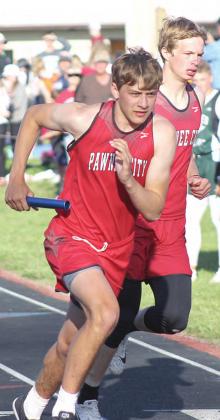 Pawnee City’s Kaden Lang takes the baton from teammate Kyle Gyhra in the 1600 M. Relay. Pawnee City won the event with a time of 3:35.49. Paula Jasa/Republican