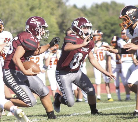 LHS’ Brock Janssen (#25, left) takes off on a run as teammate Zander Wagner (#88, center) gets out in front to block the Griffins. Paula Jasa/Republican