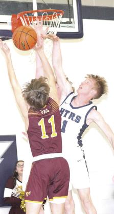 HTRS’ Brogan Dunlap (#1, right) gets his hand on a block against a Sterling shooter on Friday night. Paula Jasa/Republican
