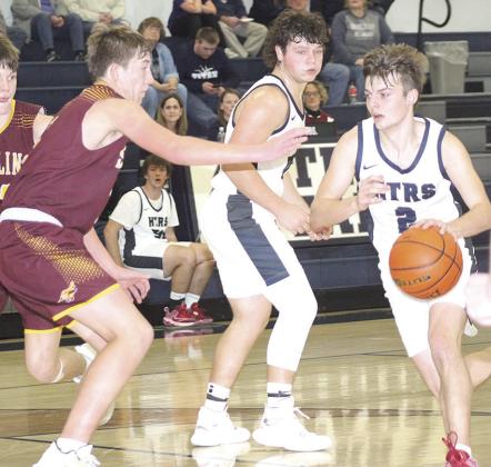 HTRS’ Brennen Vaughan (#2, right) drives past a Sterling defender and teammate Hunter Bohling (center) on his way to the hoop. HTRS defeated Sterling 47-34. Paula Jasa/Republican