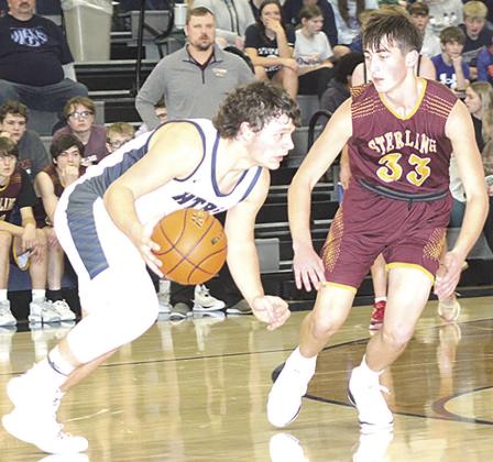 HTRS’ Hunter Bohling (left) takes off on a drive past a Sterling defender on Friday night. Bohling scored 10 points and had 10 rebounds for a double double. Paula Jasa/Republican