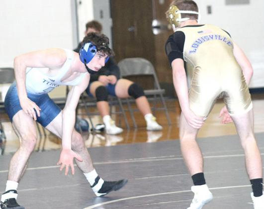 HTRS/P.C’s William Taylor (left) gets ready to shoot against Louisville’s Brock Hudson in the 138 lb. division at the HTRS Double Dual on Thursday night. Paula Jasa/Republican