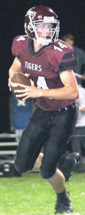 Lewiston’s Caleb Rule (#14) rolls to the right side to deliver a pass against Meridian. Rule threw two touchdown passes for the Tigers in the game. Paula Jasa/Republican