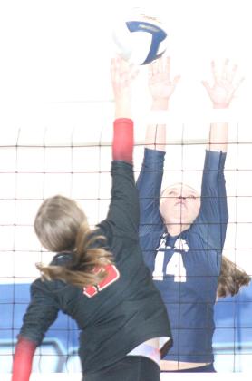 HTRS’ Ashton Bredemeier (#14, right) goes up for a block against JCC in Thursday afternoon play. Paula Jasa/Republican
