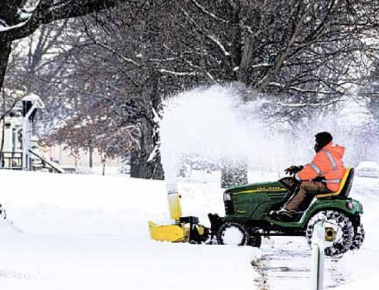 Travis Karbowksi of the Pawnee Village maintenance staff clears sidewalks Monday. Ray Kappel/Republican