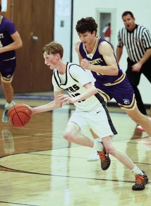 HTRS Titan Garrett Duryea runs with the ball as Tri County Trojan Jason Wehrman pursues Photo by Lorrie Novak