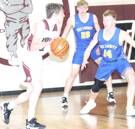 LHS’ Johnathan Burgett (#12, left) drives the ball against two Tri-County defenders. Paula Jasa/Republican