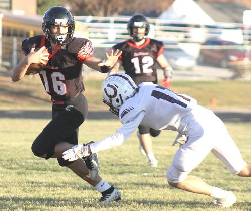 P.C.’s Anthony Kling (#16, left) returns a kickoff early against Stuart in the Class D6 State Football playoffs as teammate Andy Maloley (#12, right) looks on. Paula Jasa/Republican