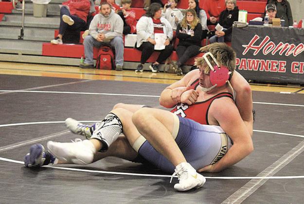 Pawnee City Indian Gauge Schuetz pins Lincoln Lutheran Warrior Bowen L’Heureux to win the match.